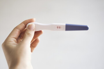 Pregnancy test. The result is positive with two strips. Pregnancy test in female hand. Pregnant woman.