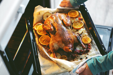 Woman cooking duck with vegetables