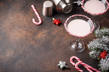 Pink peppermint martini with candy cane rim