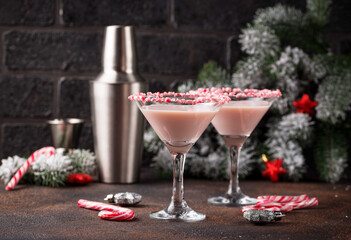 Pink peppermint martini with candy cane rim