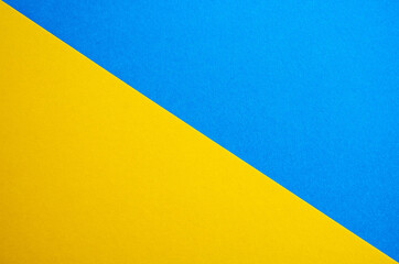 Blue-yellow background of matte suede, close-up. Velvety texture