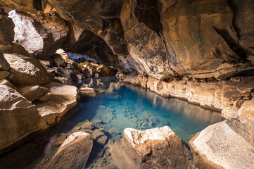 The blue waters of Grjótagjá cave in Iceland.