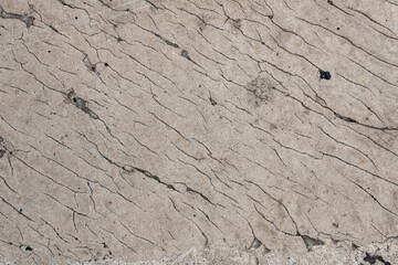 gray concrete wall with cracks. rough surface texture