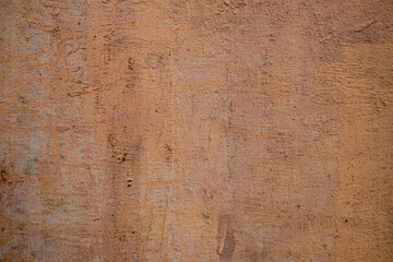 old concrete pink wall with white paint spots and black scratches. rough surface texture