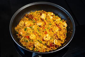 Sea Food Home made Paella Valenciana. Typical Spanish seafood paella in traditional pan. Macro close-up. Selective focus