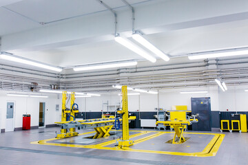 New car repair service center. equipment electric lift for cars in the service put on the epoxy floor in new car factory service