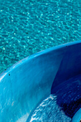 Top view of detail pf blue color a waterslide to landing in a refreshing pool in the waterpark, Background texture in Brazil