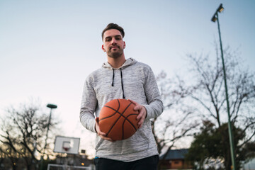 Fototapeta premium Young man playing basketball.