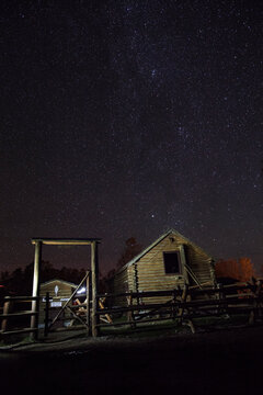 View of barn against starry sky
