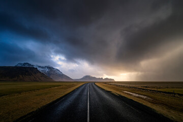 View of empty road against stormy clouds