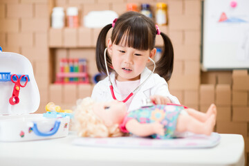 young girl pretend play doctor role  at home