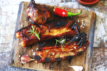 Selective focus. Macro. Baked meat ribs. Appetizing hot ribs baked in honey mustard sauce with chili pepper. BBQ ribs.