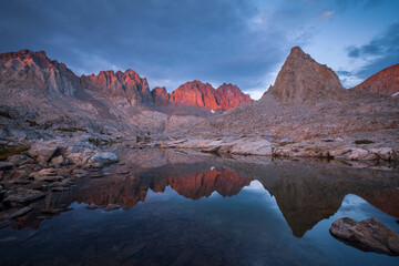 Palisade mountains reflecting in alpine lake during sunset