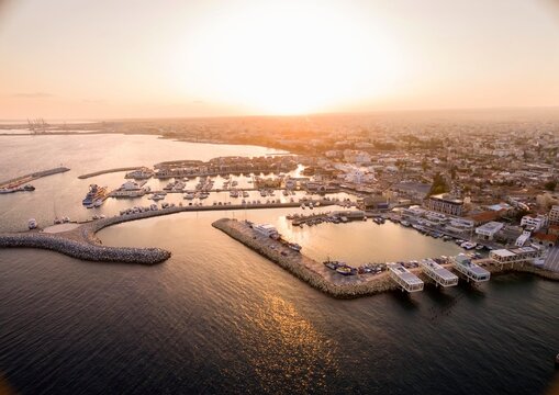 Aerial view of fishing boats docked at Limassol port during sunset