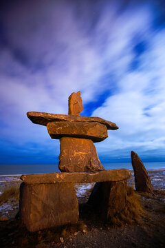Stone structure against cloudy sky at dusk