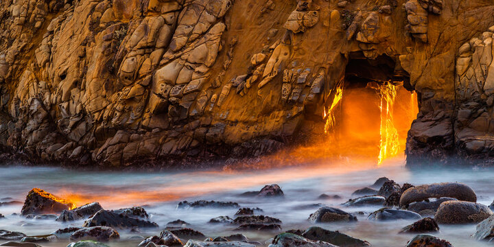 Sunlight passing through keyhole arch at Pfeiffer Beach