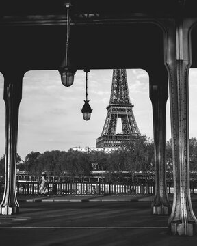 Woman walking down Paris street with Eiffel Tower in background