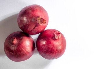 Red onions on white background in Brazil