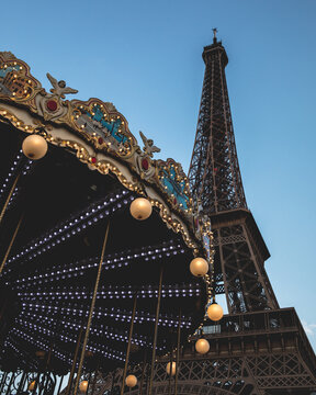 Low angle view of Eiffel Tower and carousel