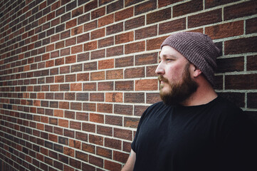 Hipster Guy in front of Brick wall