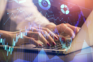 Double exposure of businesswoman hands typing on computer and forex chart hologram drawing. Financial analysis concept.