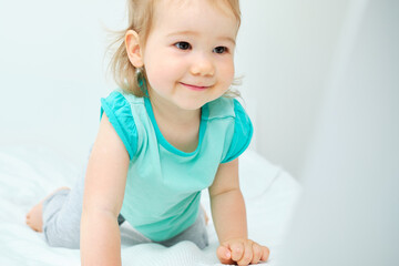 Fototapeta premium Happy smiling caucasian toddler girl watching educational video on laptop