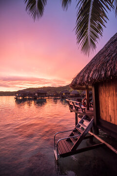 View of overwater bungalows during sunset