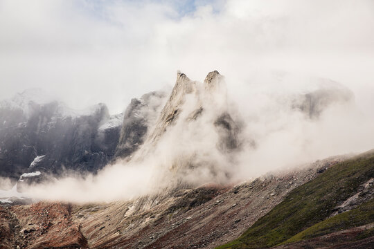 Scenic view of mountain surrounded by clouds