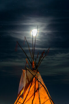 View of teepee against moon