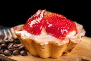 Tasty cupcake with fruit on a wooden board. Dessert prepared for serving.