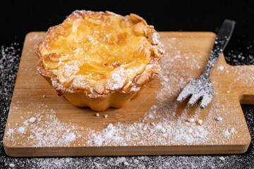 Tasty cupcake with fruit on a wooden board. Dessert prepared for serving.