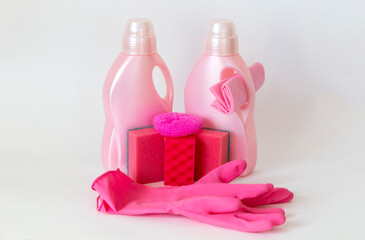 Fototapeta na wymiar Pink set of products for washing and cleaning. Rubber gloves, gel bottles, sponges and rags. Household cleaning concept