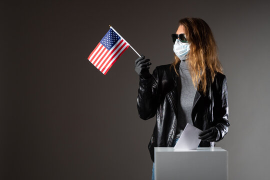 Voting In The USA Presidential Election. An American Woman Votes In An Election In A Coronavirus Pandemy. A Woman In Rubber Gloves And A Mask At The Election. Security Measures At Polling Stations.