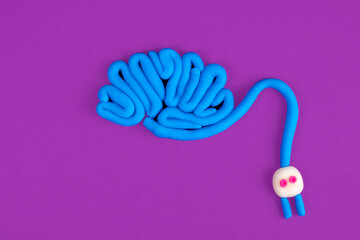 A human brain with a plug attached. Concept of brain activity on a lilac background. The concept of...