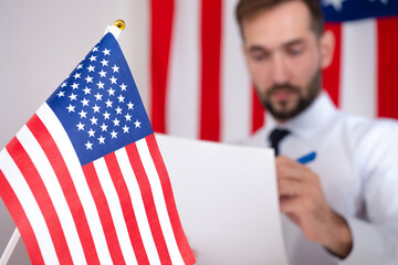An American official reads documents against the background of the US flag. Approval of documents...