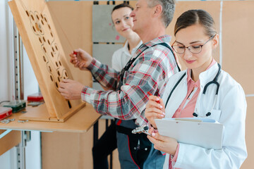 Doctor writing down results from occupational therapy dexterity test