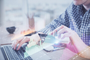 Double exposure of man hands holding a credit card and Forex graph drawing. Stock trading and digital fintech in Internet E-commerce concept.