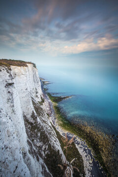 Scenic view of White Cliffs of Dover against cloudy sky