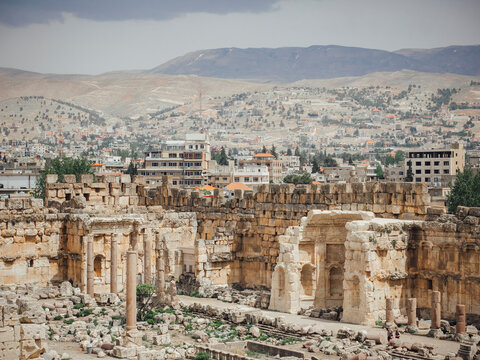 View of temple ruins with city in background