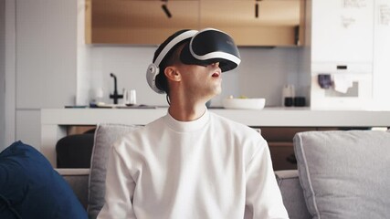 Slow motion scene video of young caucasian man using VR device fun virtual computer or video games feel excited - Powered by Adobe