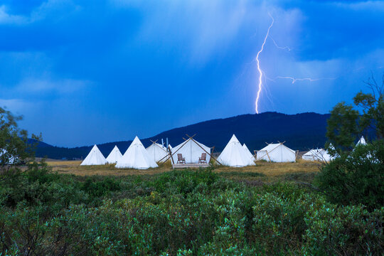 Scenic view of lightning over tents