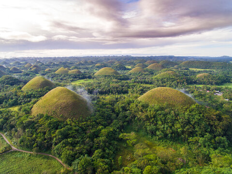 Aerial view of Chocolate Hills against cloudy sky