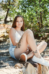 Obraz premium Tattooed girl with white shirt and shorts