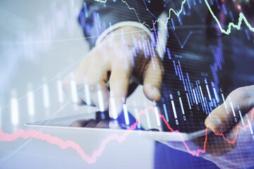 Multi exposure of man's hands holding and using a phone and financial chart drawing. Market analysis concept.