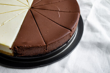 Chocolate cake cut into several pieces with decoration