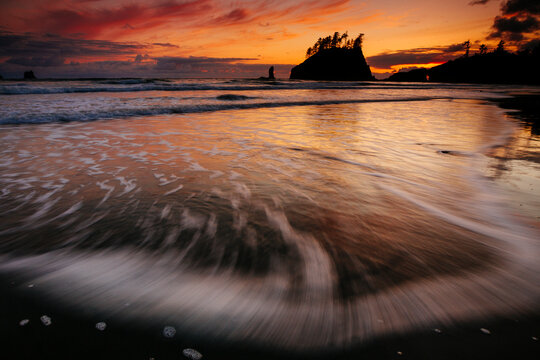 Silhouetted sea stacks along Second Beach during sunset
