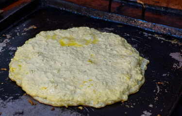 cooking typical corn arepas in old charcoal kitchen