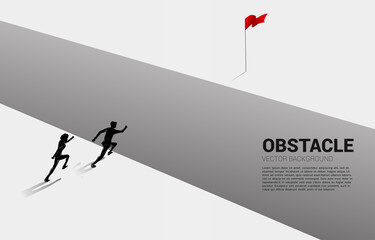 silhouette of two businessmen running across abyss to goal. concept of business challenge and obstacle