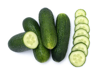 Pile of green bumpy cucumber. Group of whole and chopped fresh bumpy cucumber on white background. Fresh ingredients for a salad rich in vitamins.