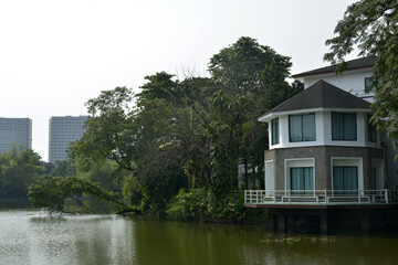 Obraz premium Ninoy Aquino parks and wildlife water lagoon plus house facade in Quezon City, Philippines